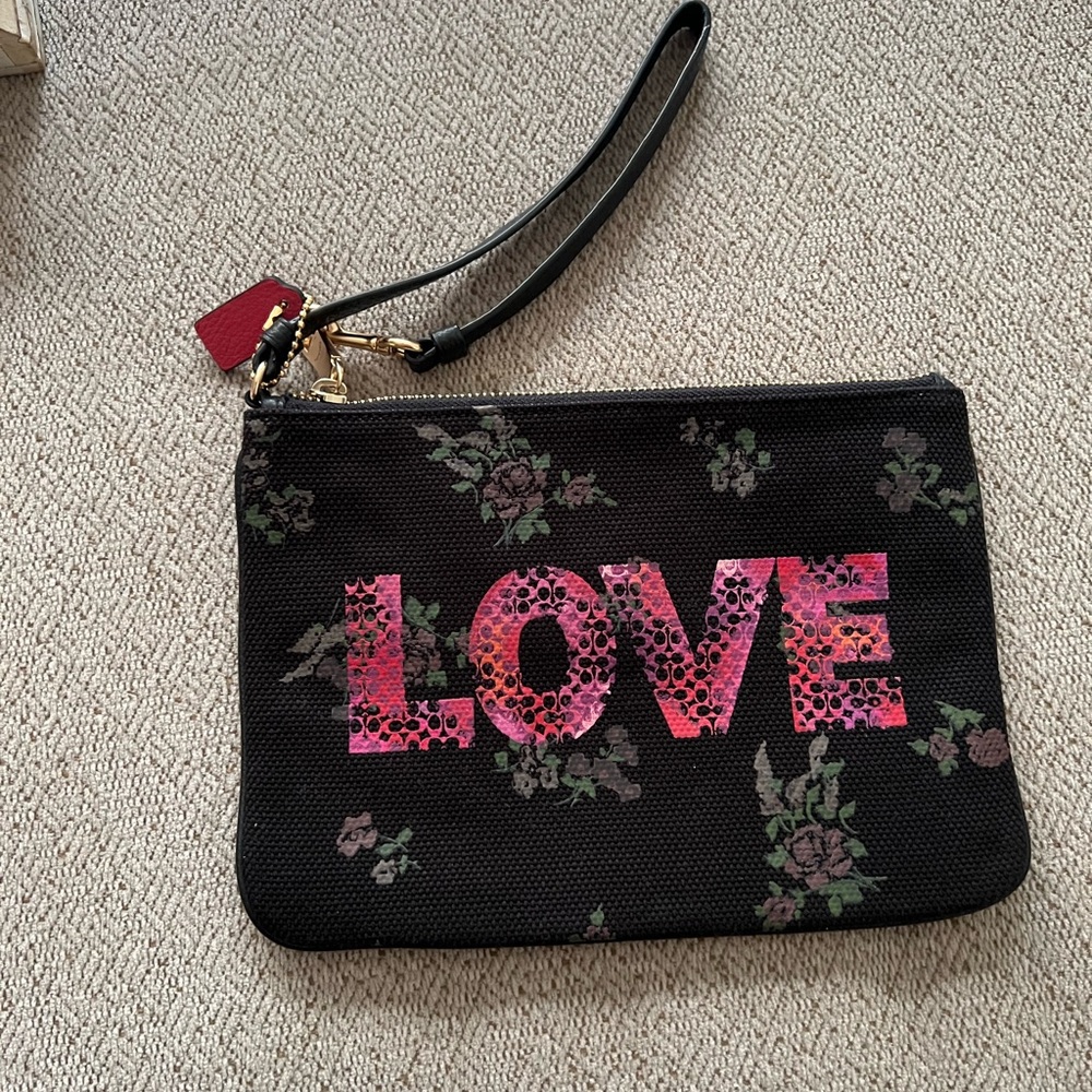 Coach NWT black floral “Love” collection wristlet pouch wallet.